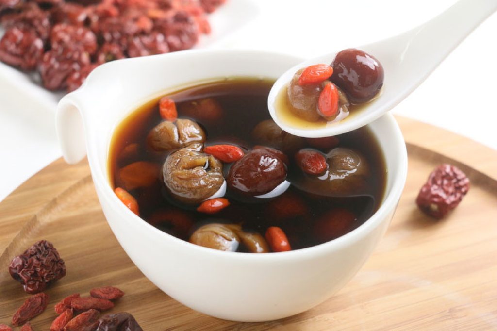 wolfberry jujube tea longan in tea cup on wooden tray